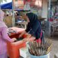 Seorang pembeli sedang menawar ikan bakar di warung Ibu Nunung, pantai Gading, Kota Mataram